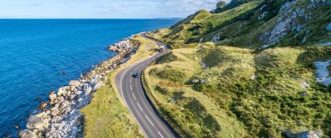 landscape with road in the middle and the ocean on the right