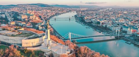 aerial photography of buildings viewing bridge and sea during daytime
