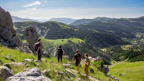 Foto van een meisje in short nabij een blauw meer nabij een bergtop in de Franse Alpen.
